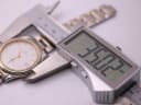 Digital caliper measuring the Zenith watch case diameter, showing a precise reading of 35.02mm.