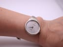 The Bijoux Birk watch worn on a wrist, showcasing its integrated silver cuff bangle design and elegant silhouette.