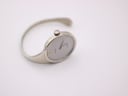 Top-down angled view of the Bijoux Birk minimalist watch, highlighting its unique oval case and seamless bangle design.