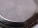 Macro shot of the case back with the serial number "15716-B11-9" engraved into the brushed metal surface.
