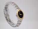 Angled shot of the Movado SE watch on a display stand, showing the curved profile and integrated bracelet.