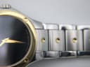 Close-up view of the watch dial and a section of the two-tone bracelet with gold accents.
