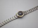 Overhead view of the Movado SE watch laid flat, displaying the full length of the two-tone steel bracelet.