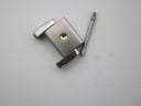Close-up of two polished metal watch links and a metal pin.