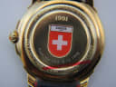 Detailed close-up of the Michel Jordi watch case back with "1991" engraving and Swiss flag emblem.