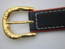 Close-up of the gold-tone buckle, clearly signed "MICHEL JORDI".