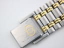 Close-up of the brushed stainless steel fold-over clasp of the Gucci 9000 M bracelet, with the gold interlocking Gs logo.