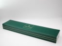The closed original green Gucci presentation box for the 9000 M watch, showing the gold "GUCCI" logo.