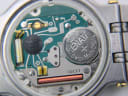Close-up view of the Swiss quartz movement inside the Gucci 9000 M, showing the Renata 371 battery and "GUCCI" engraving.