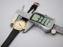 Digital caliper measuring the case diameter of the Gucci 3000 M watch, showing a reading of 33.11 mm.