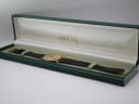 The Gucci 3000 M watch presented inside its original dark green Gucci manufacturer's box with gold branding.