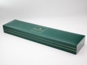 Exterior view of the original dark green Gucci manufacturer's presentation box with gold trim and branding.