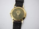 Close-up of the polished gold case back, revealing the engraved Gucci crest, "3000 M" model, and serial number.