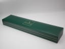 The Gucci 6000 L watch presented in its original green Gucci box, which is open to display the timepiece.