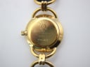 Detailed close-up of the gold-tone case back of the Gucci 6000 L, clearly showing the model '6000 L' and serial '196-447' engravings.