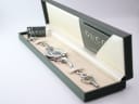 The Gucci watch bracelet on a sizing gauge, showing a wrist circumference of 203mm.