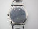 Close-up of the Gucci 122.5 case back, showing model number 122.5 and serial number 12138072.