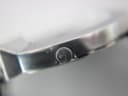 Close-up of the Gucci watch crown, clearly showing the engraved Gucci logo.