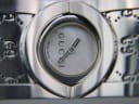 Macro close-up of the white mother-of-pearl dial, with 'GUCCI' logo, silver hands, and 'SWISS MADE' text.