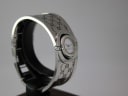 Another angled view of the Gucci 112 Twirl watch on a stand, showing the curved bangle and dial.