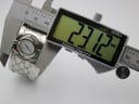 Digital caliper measuring the case diameter of the Gucci 112 Twirl watch, showing a precise reading of 23.12mm.