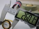 Digital calliper measuring the case diameter of the Gucci watch, displaying a precise reading of 26.01 mm.