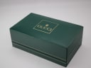 External view of the original dark green Gucci presentation box with the gold 'GUCCI' logo embossed on the lid.