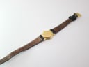 View of the Gucci 3400 L watch laid flat from the back, showing the case back and the brown inner lining of the strap.