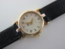 Close-up of the Gucci 3400 L dial, clearly showing the cream face, roman numerals, gold hands, and Gucci branding.