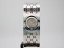 Front view of the silver Gucci 112 bangle watch with a grey dial on a stand.