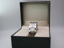 The Gucci 112 watch presented inside its original green Gucci branded box with an open lid.