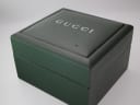 Top view of the closed original green Gucci watch box with the 'GUCCI' logo embossed on the lid.