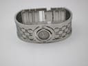 Top-down view of the Gucci 112 watch with the bangle open, showing the internal links and 'G' monogram pattern.