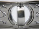 Close-up of the inside of the Gucci bangle showing model "112", serial "12281411", "GUCCI", and "WATER RESISTANT 3 ATM" engravings.