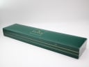 The closed original green Gucci watch box, showing the gold Gucci logo on the lid.