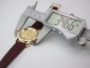 Digital caliper measuring the case diameter of the Gucci watch, clearly displaying a reading of 34.66mm.