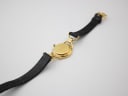 Back view of the entire Gucci 6000L watch on a white background, showing the case back and strap.