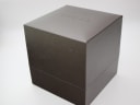 The closed original brown Gucci box with the 'GUCCI' logo embossed on the lid.