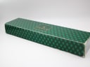 Bottom view of the original green Gucci watch box, showing a decorative pattern and the 'Gucci' logo.