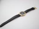 Overhead view of the Gucci 3000 M watch lying flat with the black leather strap extended, showcasing the full length.