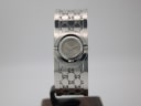 Front view of the Gucci 112 silver-tone bangle watch with grey dial, displayed on a watch stand.