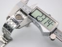 Digital caliper measuring the Gucci 112 watch case diameter at 23.14mm, confirming the watch size.