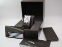 The Gucci 112 watch presented in its original brown Gucci box, alongside its original papers and cushion.