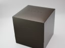 Exterior view of the original dark brown Gucci presentation box with 'GUCCI' embossed on the lid.