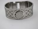 Rear view of the Gucci 112 watch head, showing the engraved GG monogram continuing across the case back.