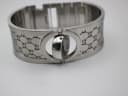 Close-up side profile of the Gucci 112 watch head, illustrating its integration into the wider bangle.