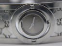 Detailed close-up of the grey Gucci 112 watch dial with two silver hands and subtle 'GUCCI' branding.