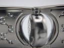 Macro shot of the Gucci 112 case back engravings, showing model number "112", serial number "11421030", and "WATER RESISTANT".
