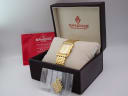 Open Sandoz original brown box with the watch on a cushion, red papers, and extra bracelet links in a bag.