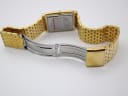 Rear view of the Sandoz watch, showing the brushed stainless steel case back and the inner clasp of the bracelet.